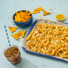 Seasoned tortilla chips on plates with small seasoning bowls