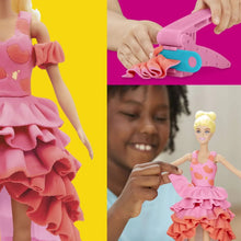 Fashion doll wearing a pink layered ruffle dress