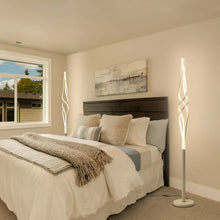 Spiral LED floor lamp with tall white twisted shade and round base
