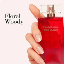 Elizabeth Arden Red Door eau de toilette bottle held in a hand