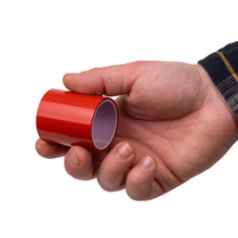 Hand holding red translucent tail light tape roll