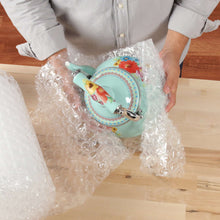 Clear bubble cushion sheet cushioning a decorative plate on a floor