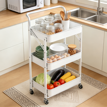 White 3-tier rolling cart with wire shelves holding jars, plates, produce, and eggs.