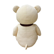 Back view of a cream corduroy plush bear, showing its small tail