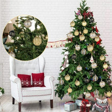 Christmas tree decorated with mixed gold and dark ball ornaments, including geometric and striped baubles