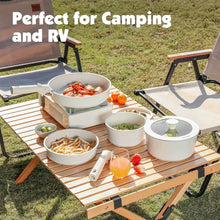 White speckled camping cookware set with detachable handles on an outdoor table