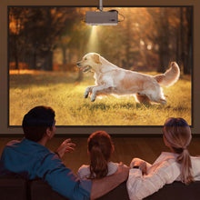 Mini projector projecting outdoor movie of a dog on a large wall screen