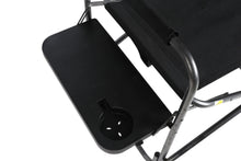 Black side table on folding director's chair with metal arms and frame