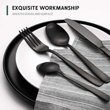 Matte black cutlery set with spoon, fork, and knife on white plate