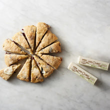 Salted butter sticks next to shortbread rounds on a marble surface
