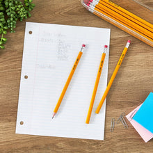 Yellow unsharpened wood pencils with red erasers on lined notebook