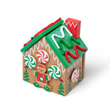 Wooden gingerbread house play set with green roof, red panel, and icing strings