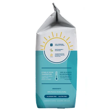 Whole bean coffee bag with blue label and circular roast freshness icon