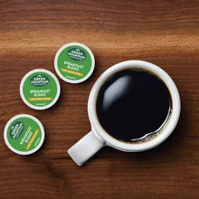 Green Mountain Breakfast Blend K-Cup pods and mug on wooden surface