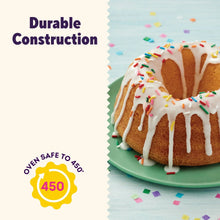 Bundt cake with white icing and colorful sprinkles on a green plate