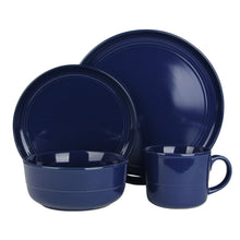 Blue stoneware dinnerware set with plates, bowl, and mug in glossy glaze