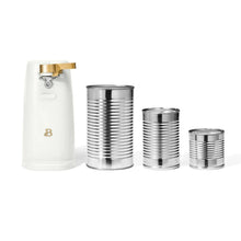 White electric can opener beside three silver canisters of different sizes