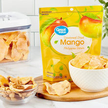 Sweetened dried mango pouch with bowls of dried mango slices and container