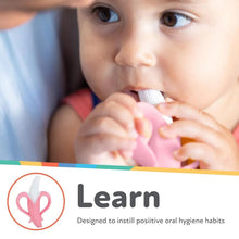 Pink infant toothbrush with white bristles near baby’s mouth