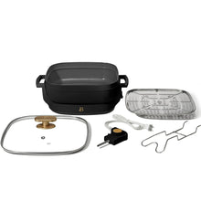 Electric skillet set with black base, glass lid, perforated rack, and power cord