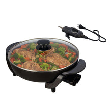 Black electric skillet with glass lid, food inside, removable temperature control