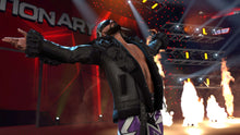 Wrestler in dark outfit raising arms on stage with fireworks behind