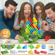 Family playing with green dinosaur balance stacking toy and multicolor square blocks
