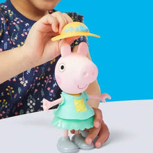 Small Peppa Pig doll in mint outfit, child holding a yellow hat