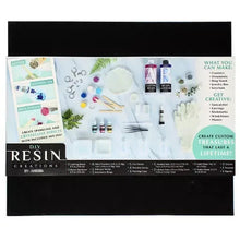 Epoxy resin craft kit in box with bottles, droppers, molds and stirring tools