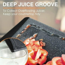 Dark grey cutting board with deep juice groove collecting liquid from chopped fruit.