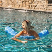 Person reclining in a pool with blue patterned pool noodle floats
