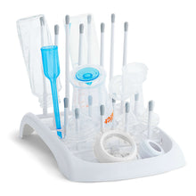 White drying rack holding clear and blue bottles and small parts