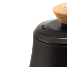 Electric gooseneck kettle lid close-up with cork topper and vent holes