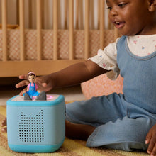 Ms. Rachel audio figurine on blue Toniebox speaker on a child’s table