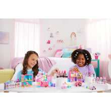Mini doll house playset on table with pastel accessories and small dolls