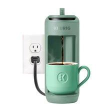 Keurig K-Mini Mate pod coffee maker in Glamping Green with mug and pouring coffee