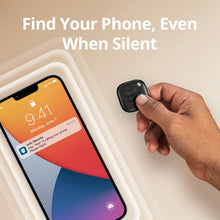 Black key finder tag held in a hand