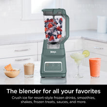 Sage Ninja blender with ice and berries in the clear pitcher, plus two frozen drinks.