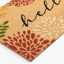 Coir doormat close-up corner with 'hello' script and red floral print