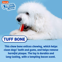 Dog resting with Tuff Bone chew toy; red textured center visible in mouth.
