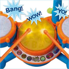 Close-up kids drum set with yellow center drum, orange rim, and side speaker pads