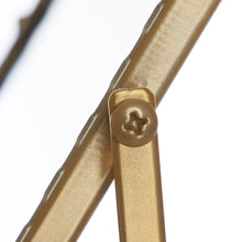Gold hinge knob on tabletop mirror frame support
