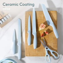 Ceramic-coated knives with light blue handles, wooden board, and kitchen shears
