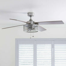 Indoor ceiling fan with light and four blades, shown from ceiling-mounted angle