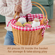Woven picnic basket with pink-and-white checkered fabric lining and handle