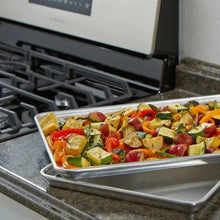 Aluminum sheet pan on oven rack filled with roasted vegetables