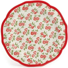 Dinner plate with cream surface, red floral pattern, and red scalloped border