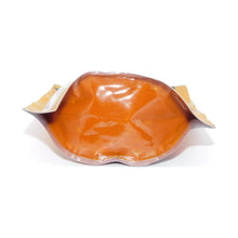 Shelf-stable tikka masala sauce pouch with amber filling, sealed plastic