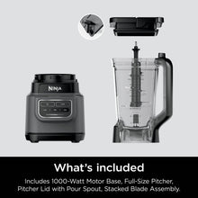Dark gray blender motor base with clear pitcher and stacked blade assembly components