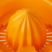 Orange reamer cone on citrus juicer with ridged strainer interior